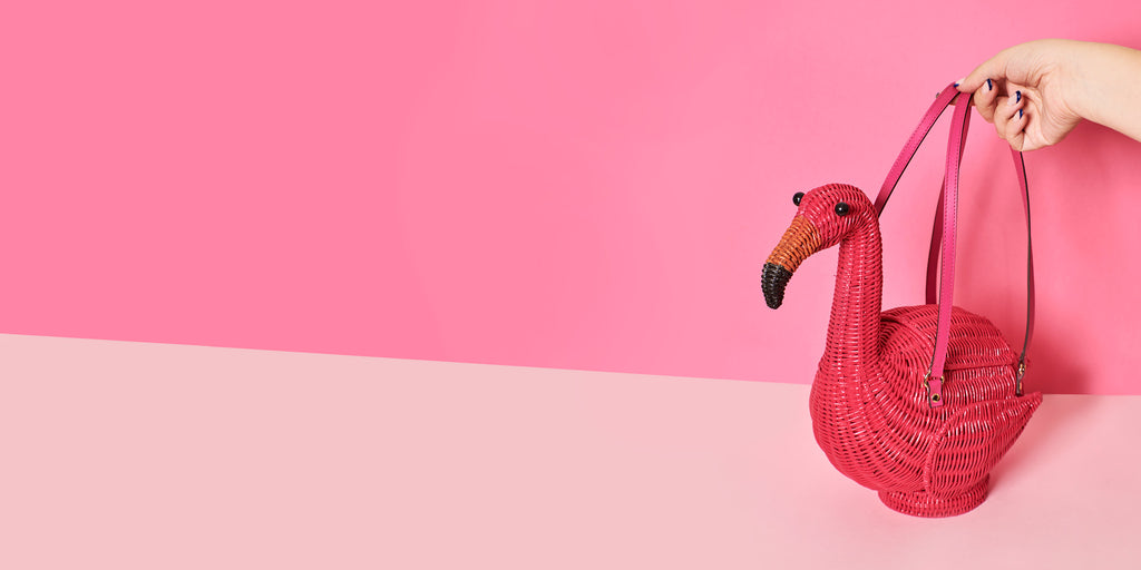 Wicker Darling flamenco flamingo purse flamingo basket sits in a colourful background