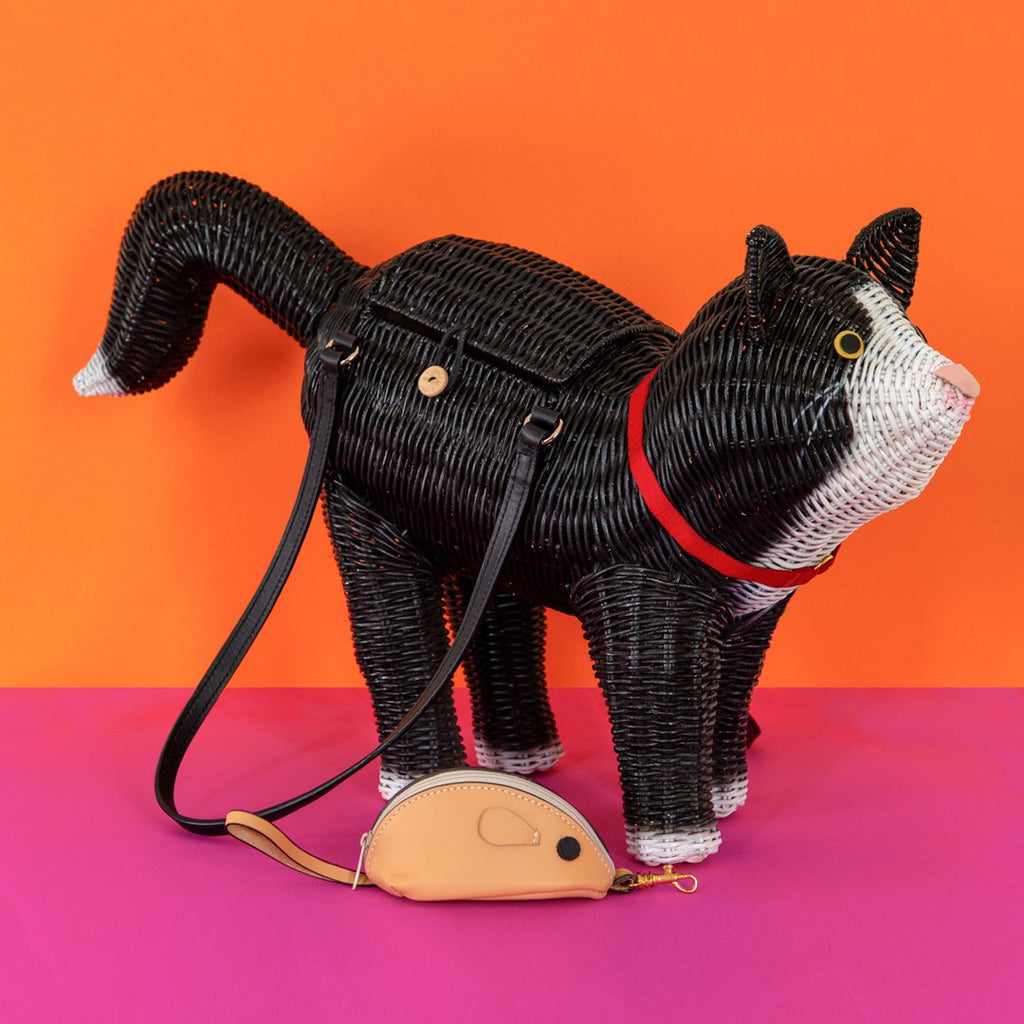 Animal shaped Purse Wicker Darling Oscar the cat purse is a black and white cat purse with mouse coin purse that sits in front of a colourful backkground