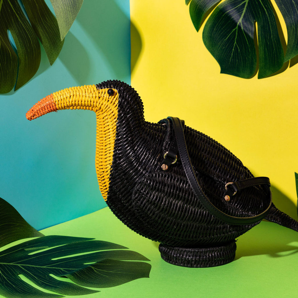 Wicker Darling black Toucan purse toucan bag in a colourful room