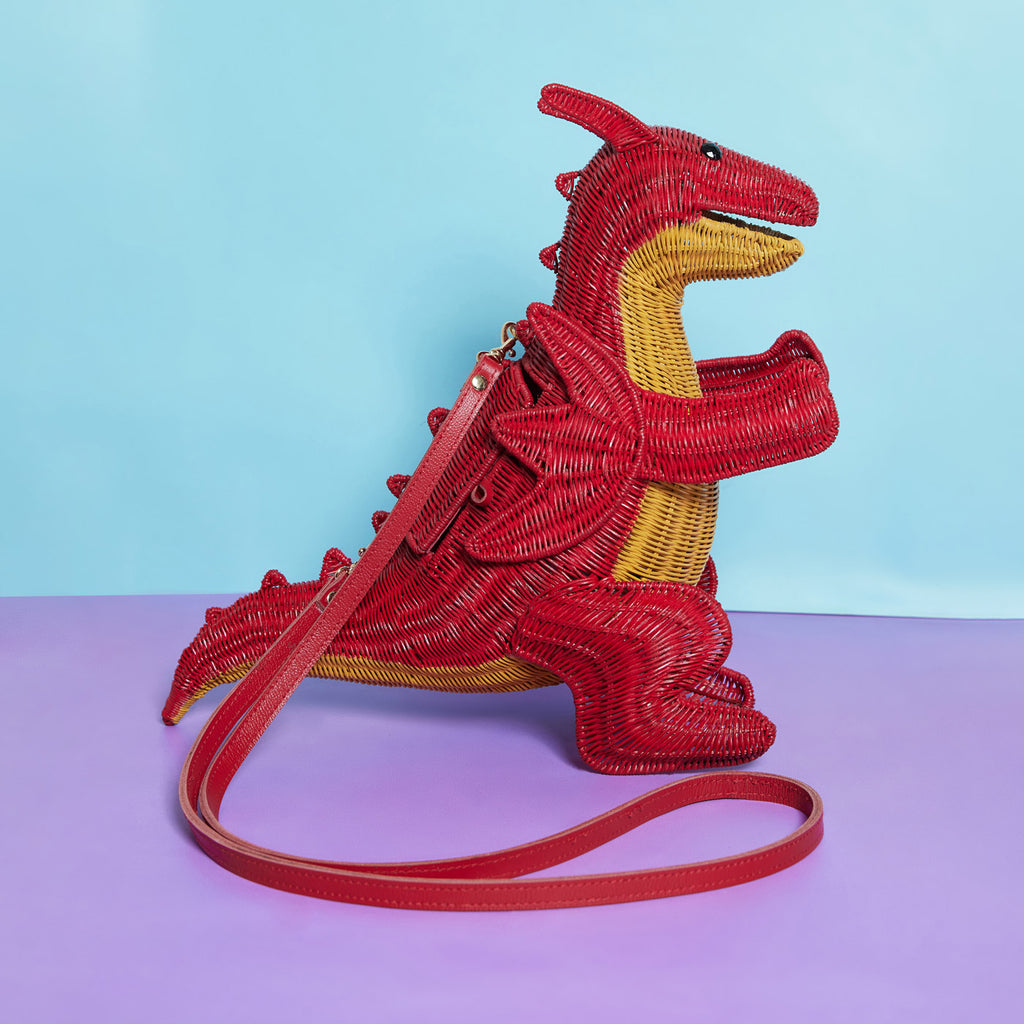 Wicker Darling red dragon purse fantasy handbag sits in a colourful background