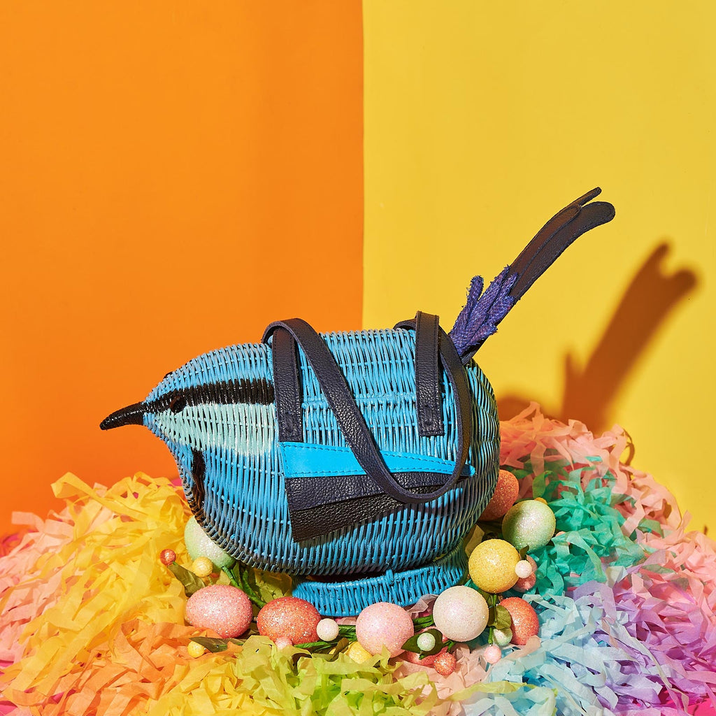 A splendid fairy wren (one of Australia's cutest animals) is a Wicker Darling handbag and sits on a colourful confetti nest