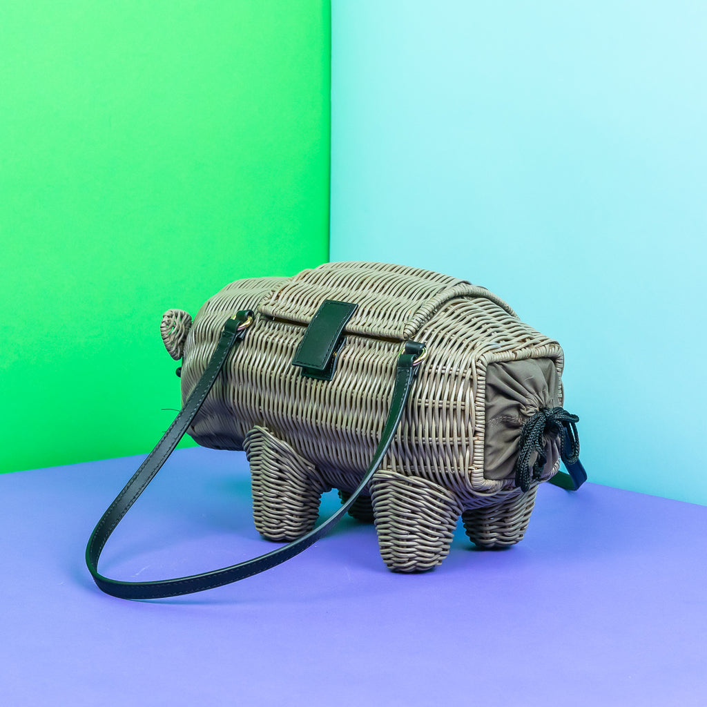 Wicker Darling Wilbur the wombat shaped handbag australiana purse sits in a colourful background.