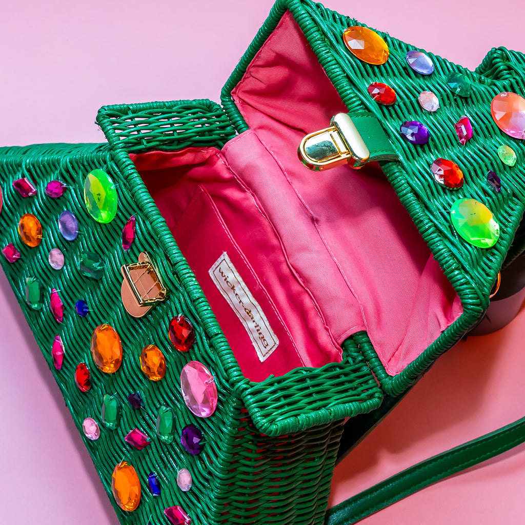 Wicker darling bejewelled christmas tree bag purse sits in a colourful set.