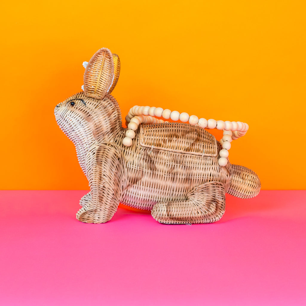 Wicker Darling Lope Jackolope purse jackolope handbag features wooden bead detailing and sits in a colourful room.