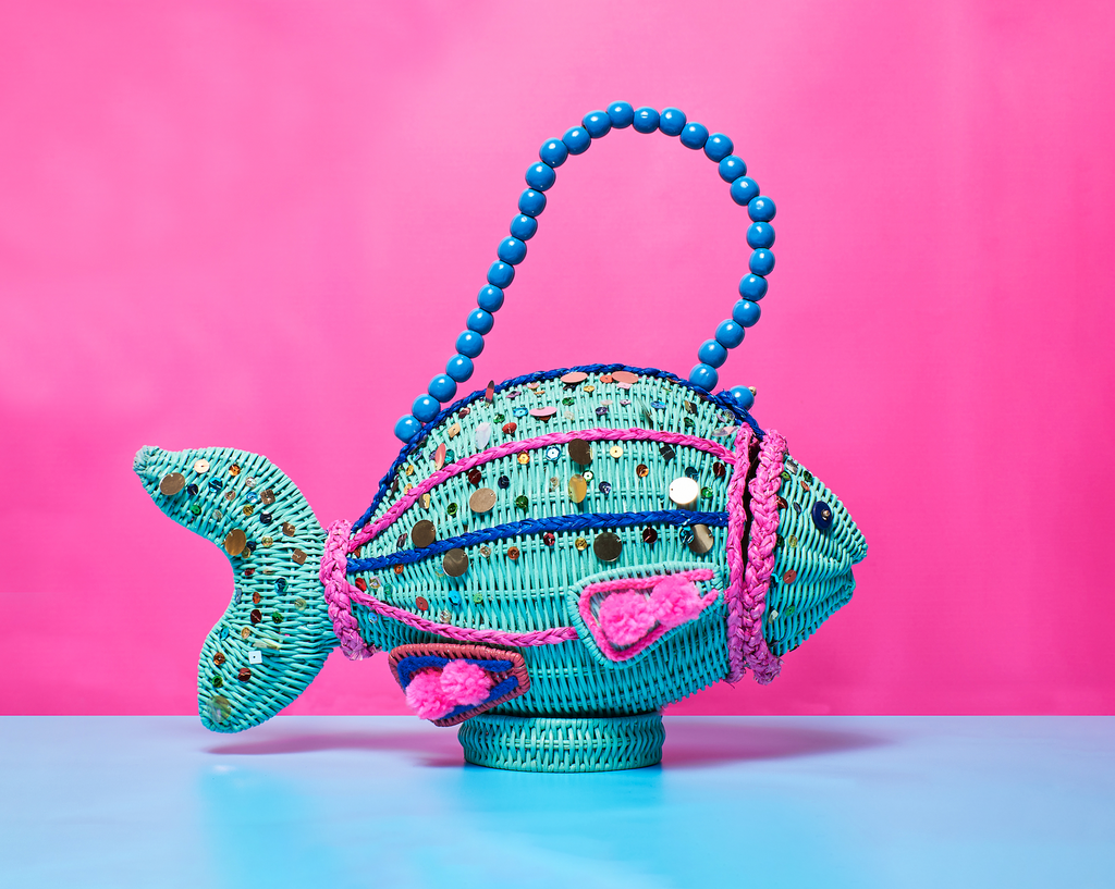 Animal shaped purse Wicker Darling Bubbles the fish custom wicker bags fish wicker handbag sits bejewelled in front of a pink background.