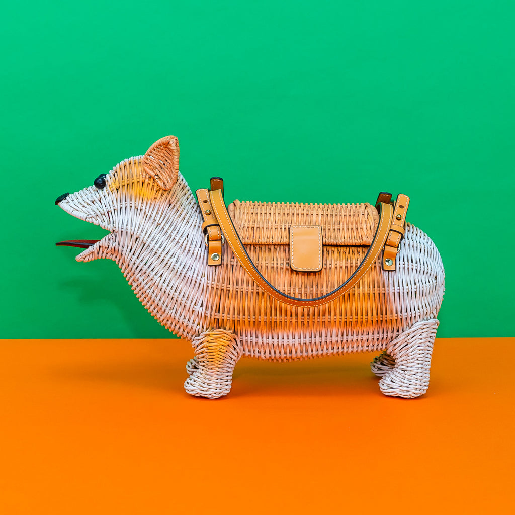 A profile view of Wicker Darling's rattan corgi novelty bag.