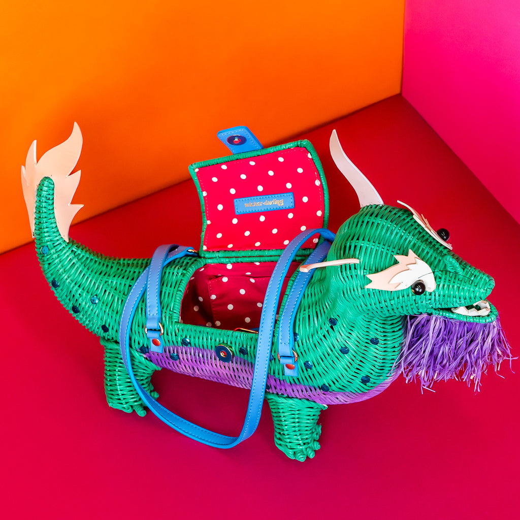 Wicker Darling Xiao Long Nü dragon handbag dragon purse features sequin embellishment and sits in a colourful background. 