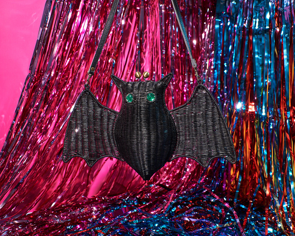 Wicker Darling Batholomew the cute bat purse sits in front of a tinsel wall