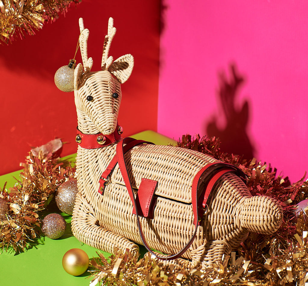 Wicker Darling Jingle Bell the Reindeer purse is the perfect holiday purse and is sitting in festive tinsel
