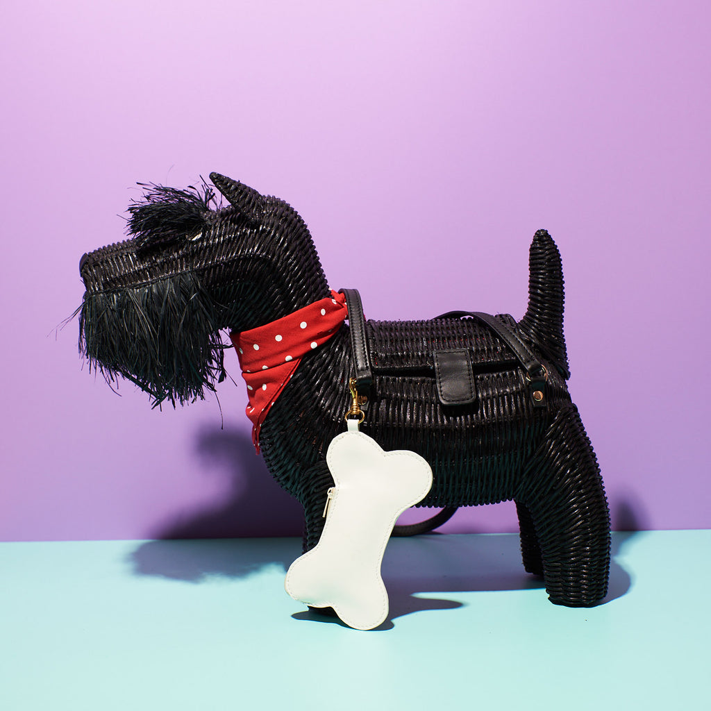 Wicker Darling animal handbag Morris the Scottie scottish terrier bag sits in a colourful bacground