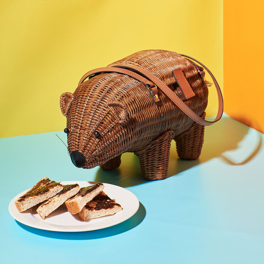 Animal shaped purse Wicker Darling Wally the Wombat is the cutest wombat bag and sits eating some vegemite toast in front of a colourful background
