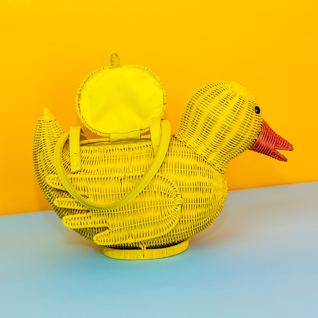 Wicker Darling yellow rubber duck handbag rubber duck purse sits in a colourful background.