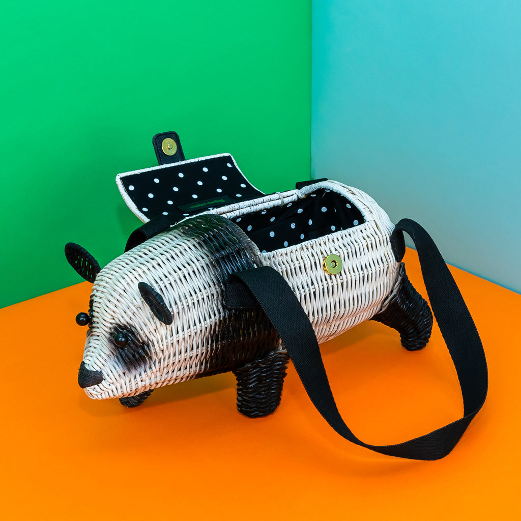 Diagonal view of Wicker Darling novelty bag, Amanda the Panda. Her lid is open, revealing a black and white pindot lining. 