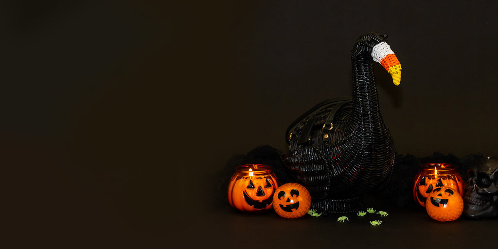 Wicker Darling sppok the halloween flamingo shaped purse sits in a black background. 