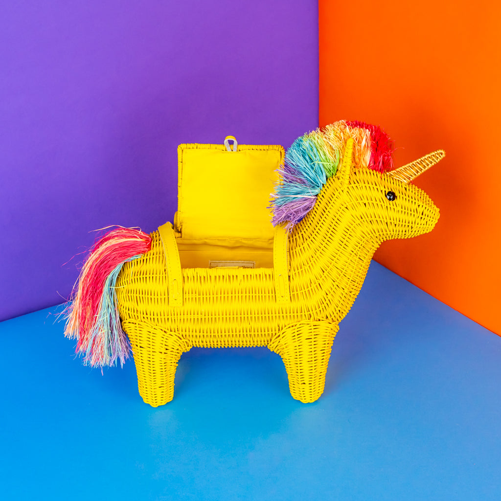 Yellow wicker unicorn bag with a rainbow mane on a blue, orange, and purple background