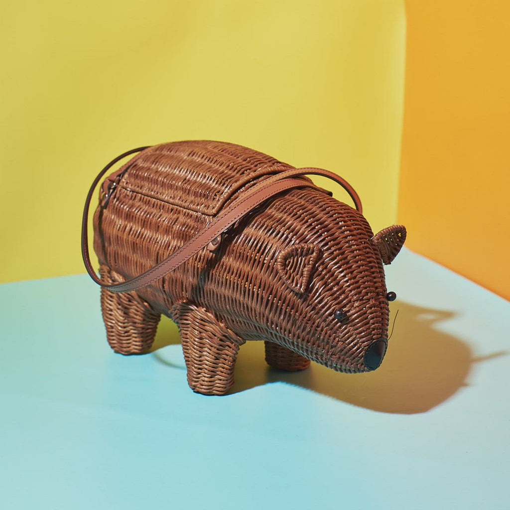 Wicker Darling cutest wombat bag australiana handbag sits in a colourful room