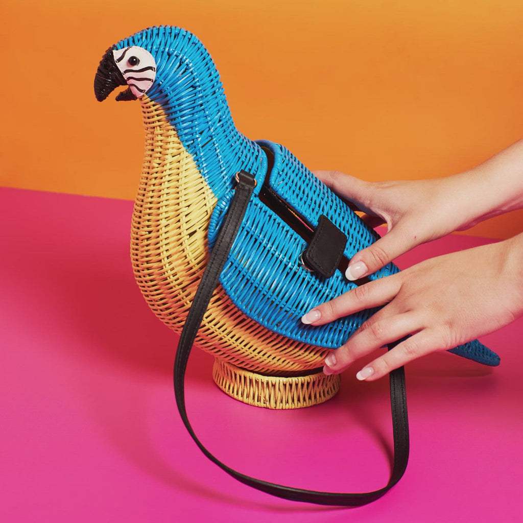 Wicker Darling blue macaw bag macaw purse is opened and closed in a colourful room.
