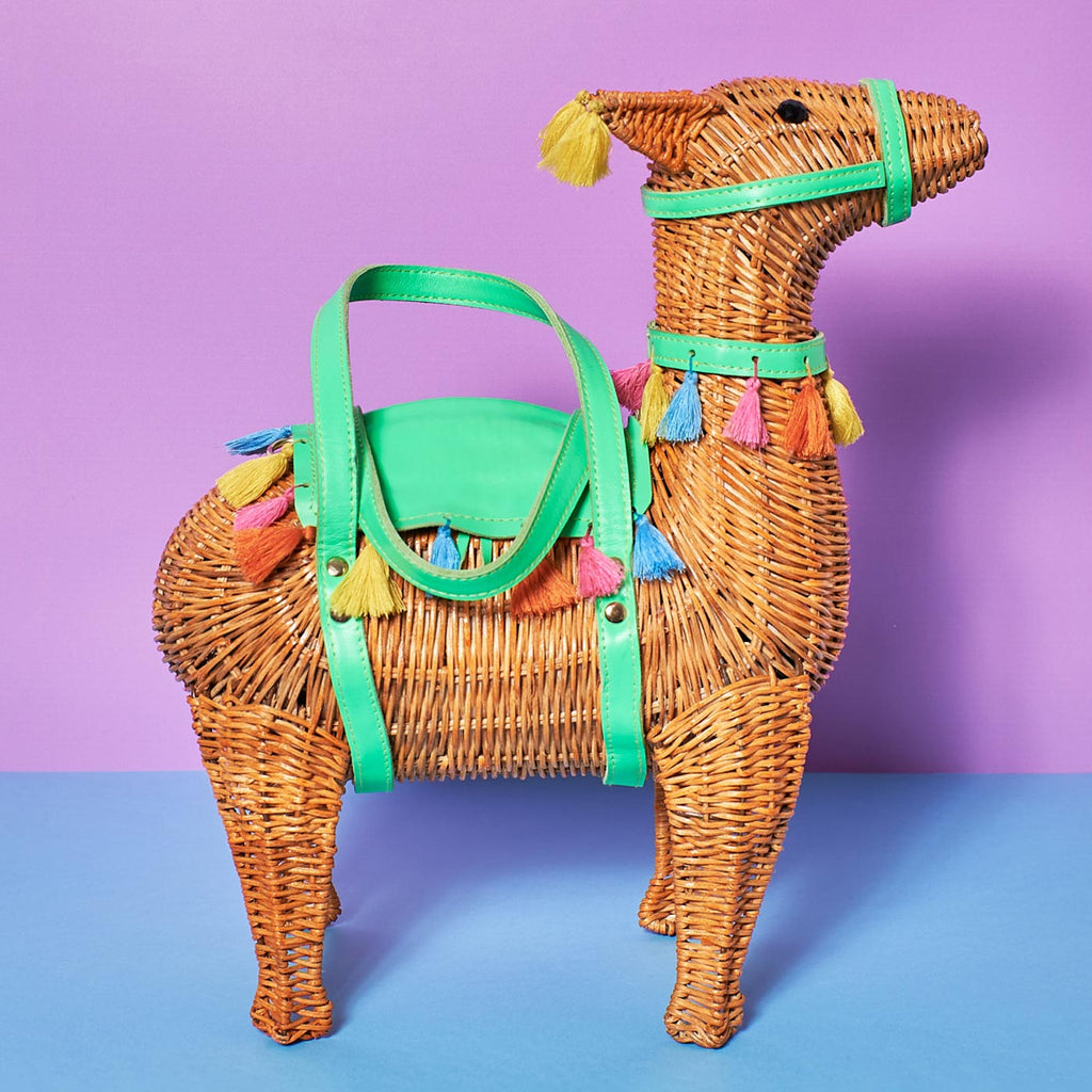 Wicker Darling Llama purse llama shaped basket sits in a colourful room
