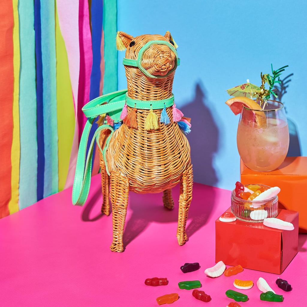 Wicker Darling Llama purse llama shaped basket sits in a colourful room