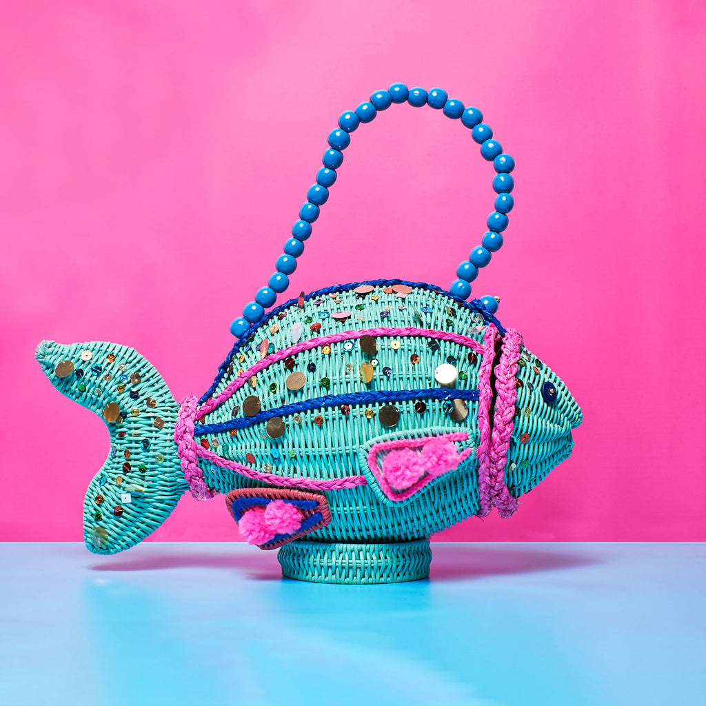 Wicker Darling bubbles fish wicker handbag fish purse sits in a colourful background