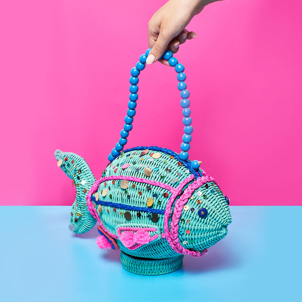 Wicker Darling bubbles fish wicker handbag fish purse sits in a colourful background