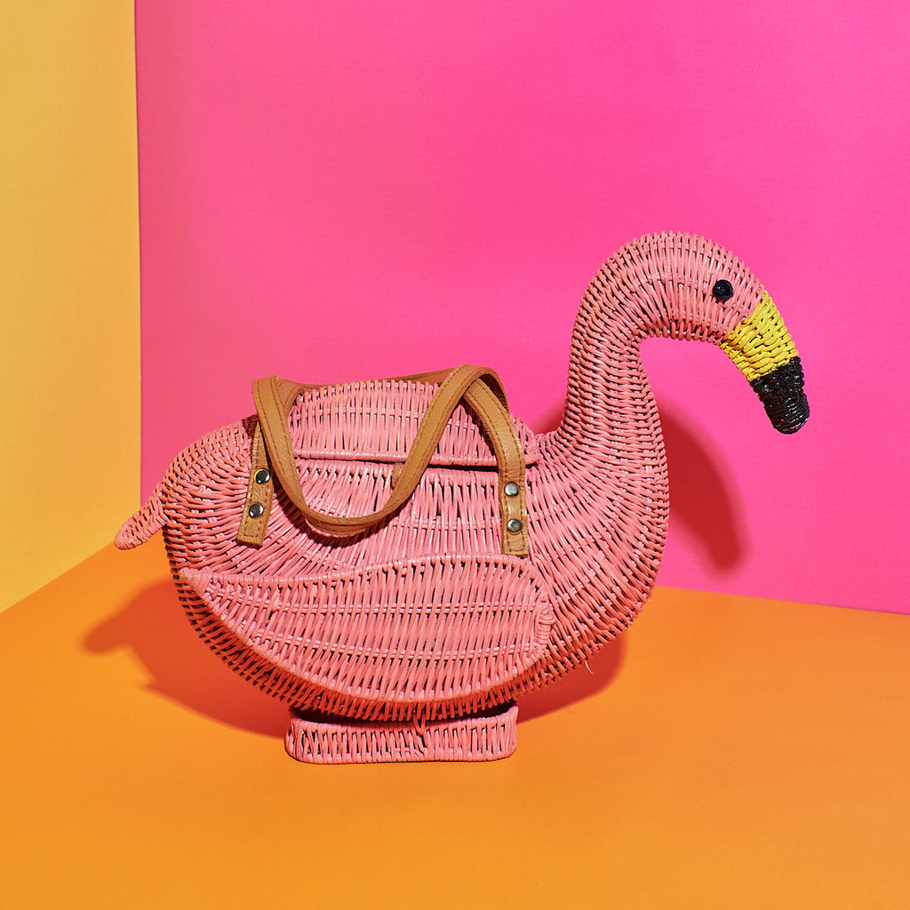 Wicker Darling chile Flamingo basket flamingo tote bag sits in a colourful background