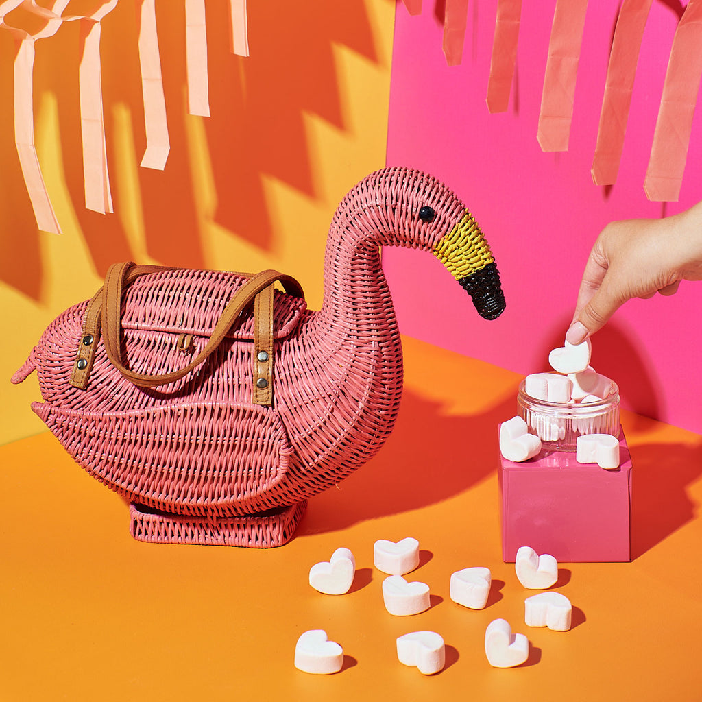Wicker Darling chile Flamingo basket flamingo tote bag sits in a colourful background