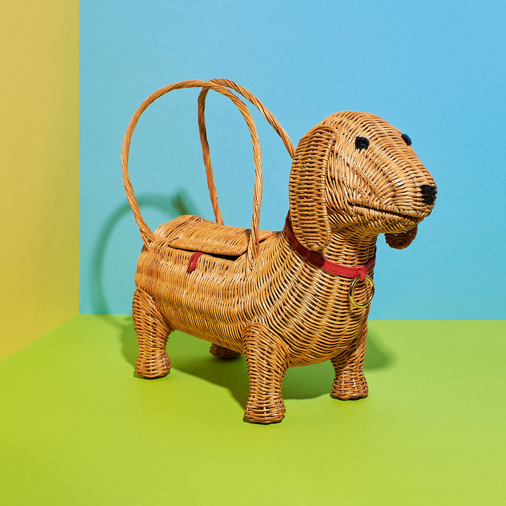 Wicker Darling chorizio Sausage Dog handbag dachshund handbag sits in a colourful background