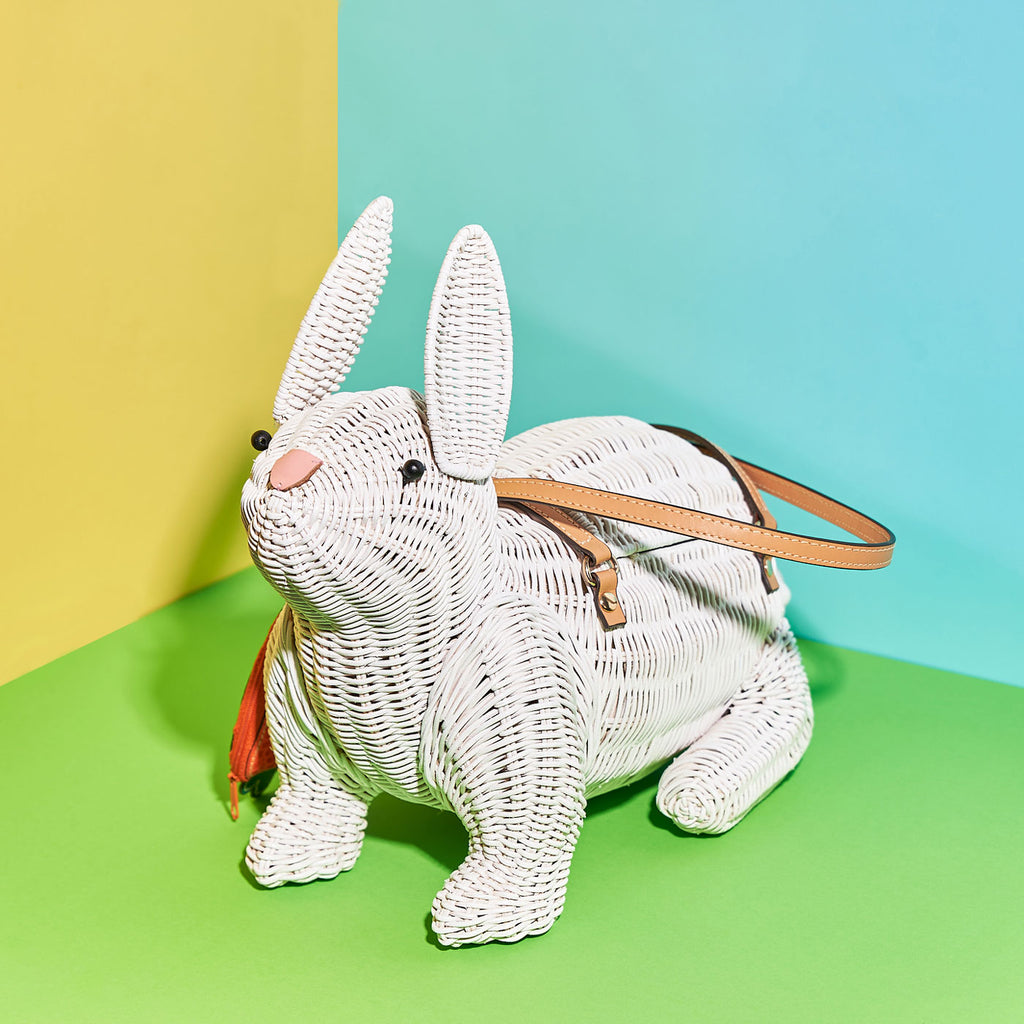 Wicker Darling harvey rabbit shaped purse bunny bag sits in a colourful background