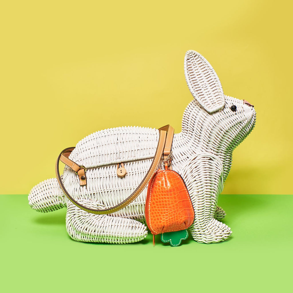 Wicker Darling harvey rabbit shaped purse bunny bag sits in a colourful background