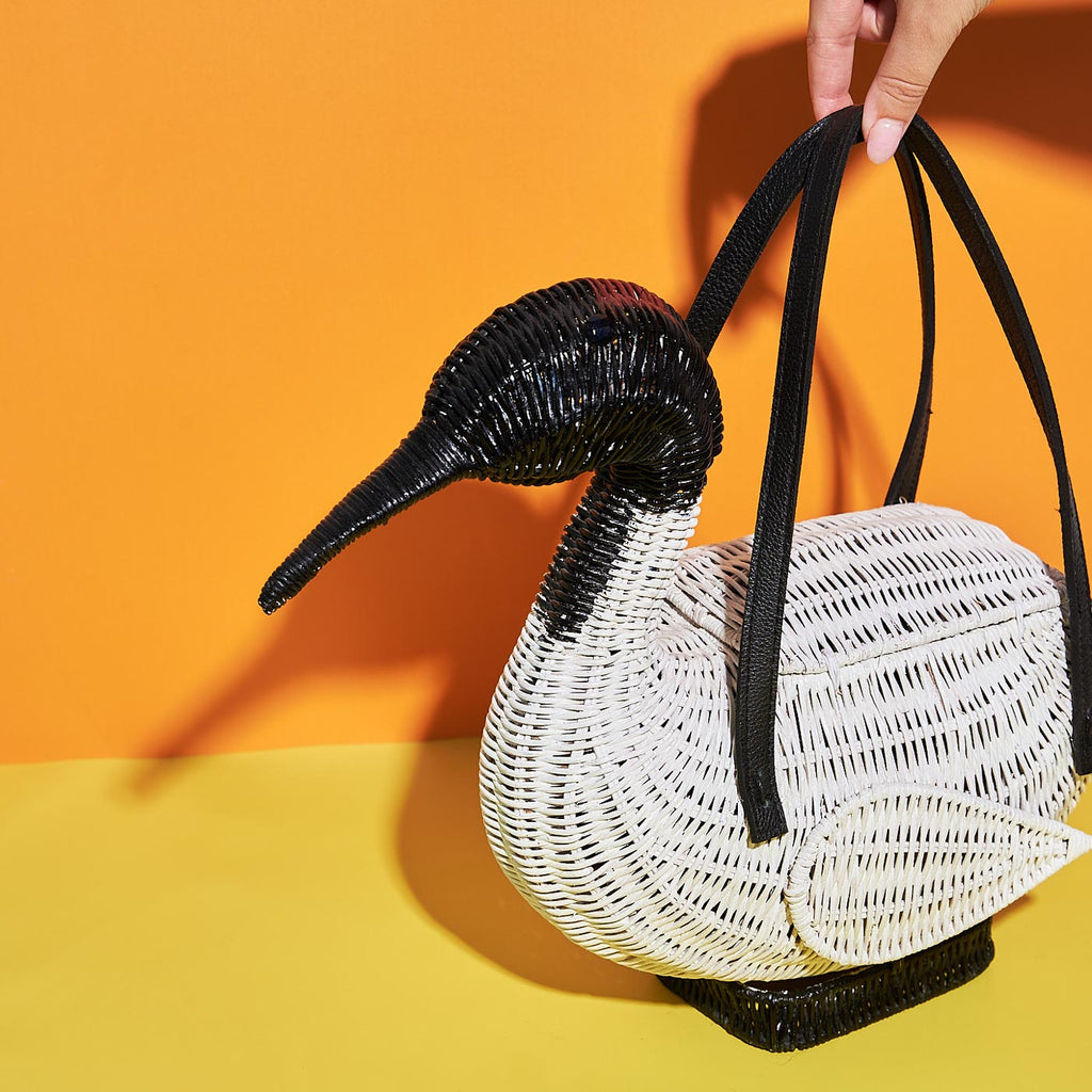 Wicker Darling ita ibis bag bin chicken wicker-bag sits in a colourful room