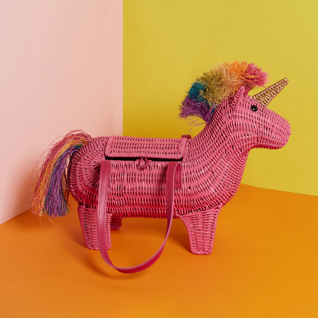 Viola the pink unicorn bag has a rainbow mane and sits in a colourful background