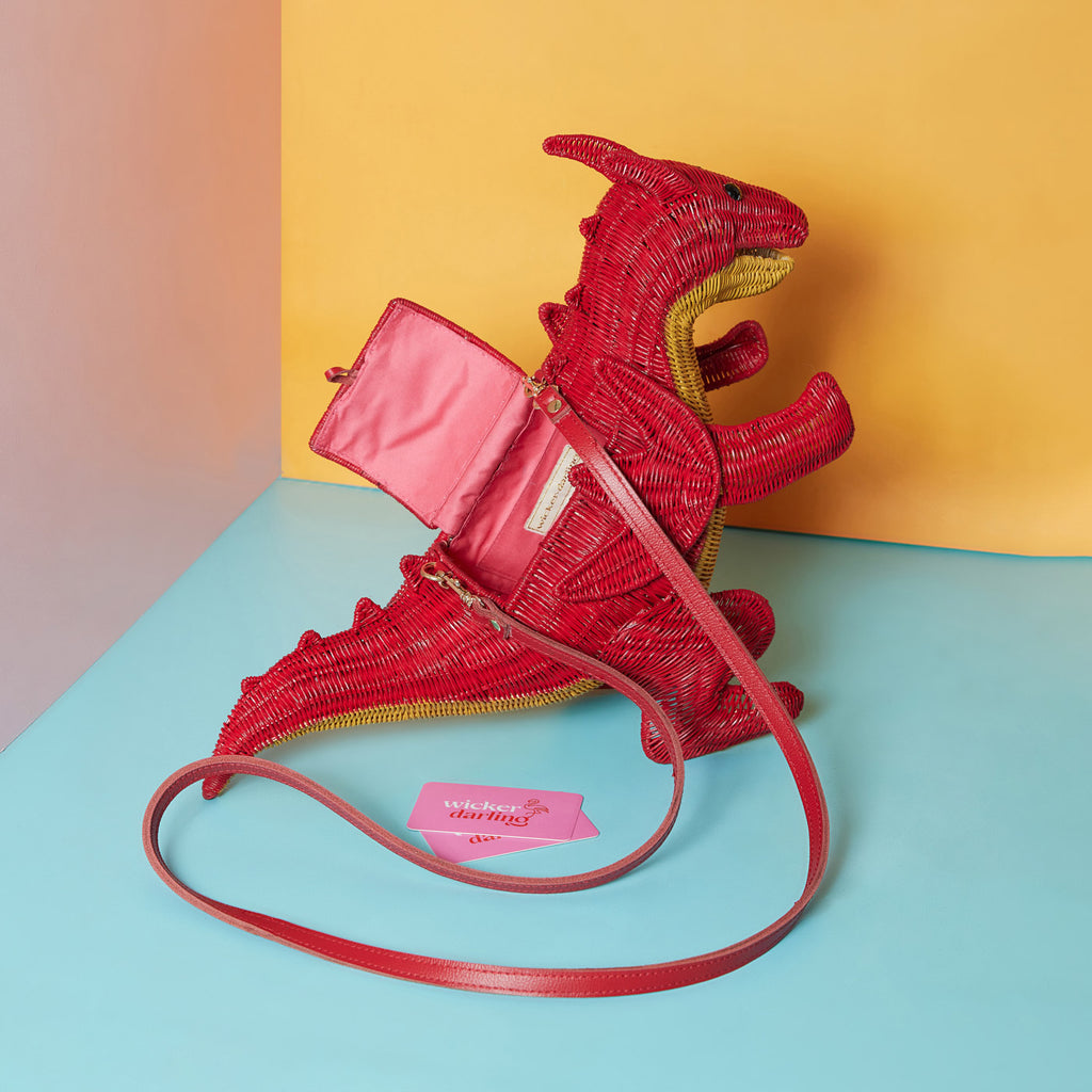 Wicker Darling red dragon purse fantasy handbag sits in a colourful background