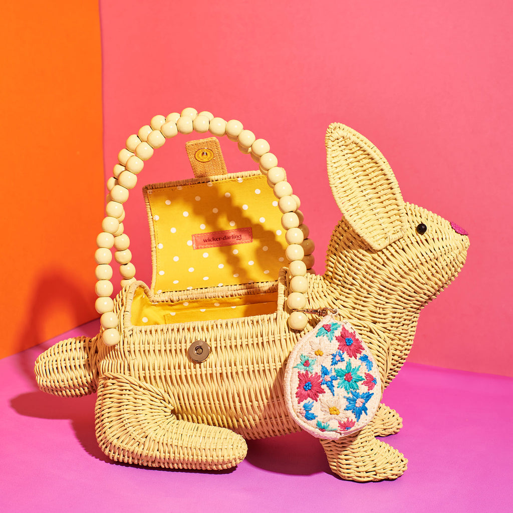 Wicker darling easter rabbit easter bunny purse vegan purse sits in a colourful room