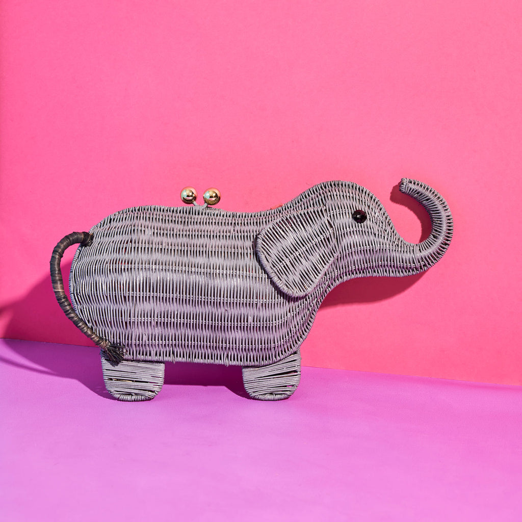 Wicker darling elephant clutch elephant bag in a colourful room