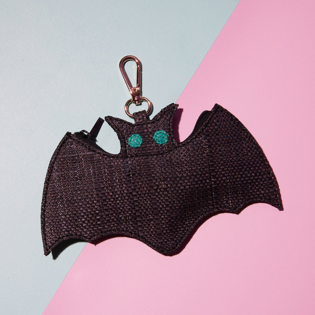 Wicker Darling Benedict Jr bat coin purse bat shaped purse sits on a colourful background