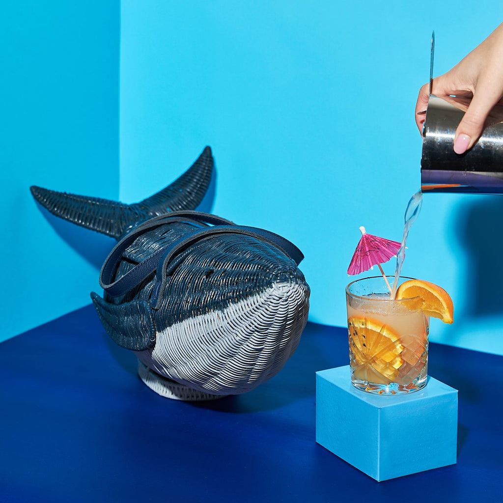 Wicker Darling moby wick whale purse blue whale wicker basket in a blue background