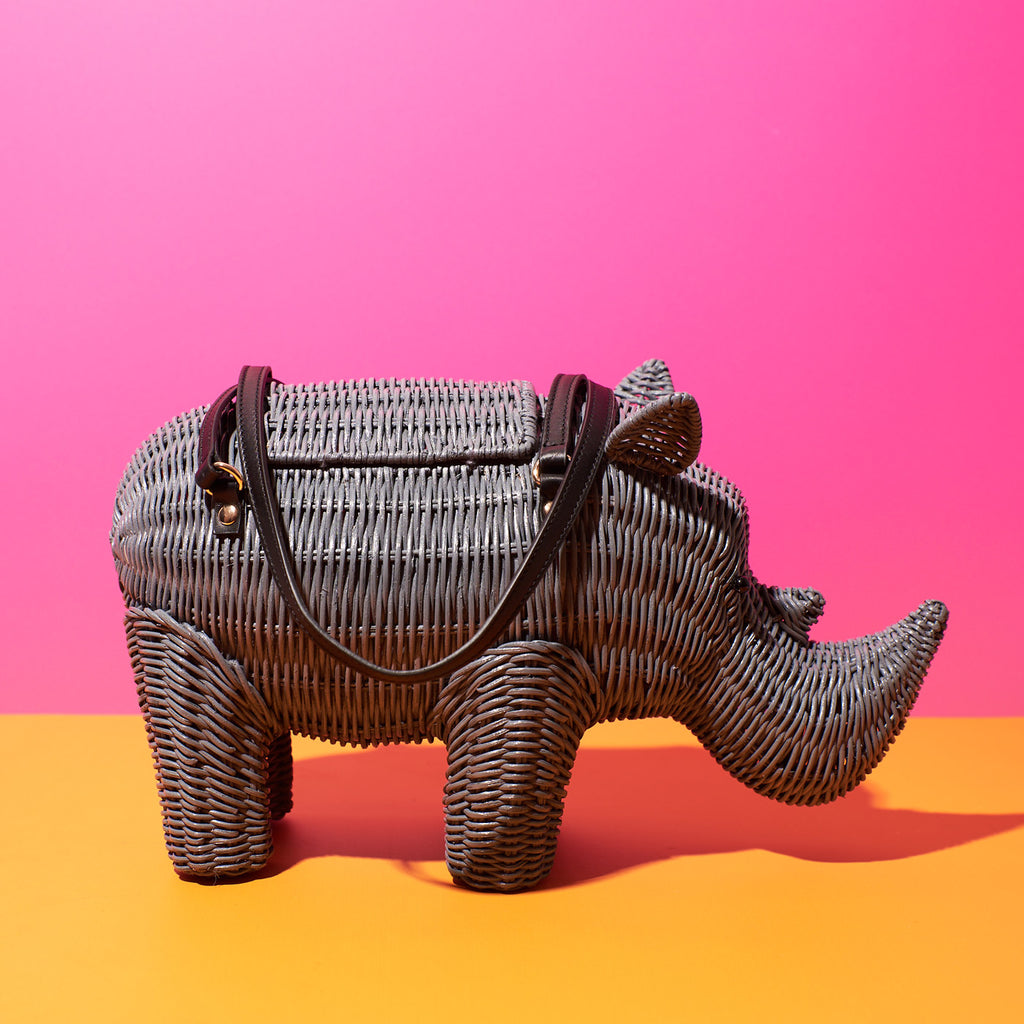 Wicker Darling Rhino purse rhino shaped bag sitting in a brightly coloured room