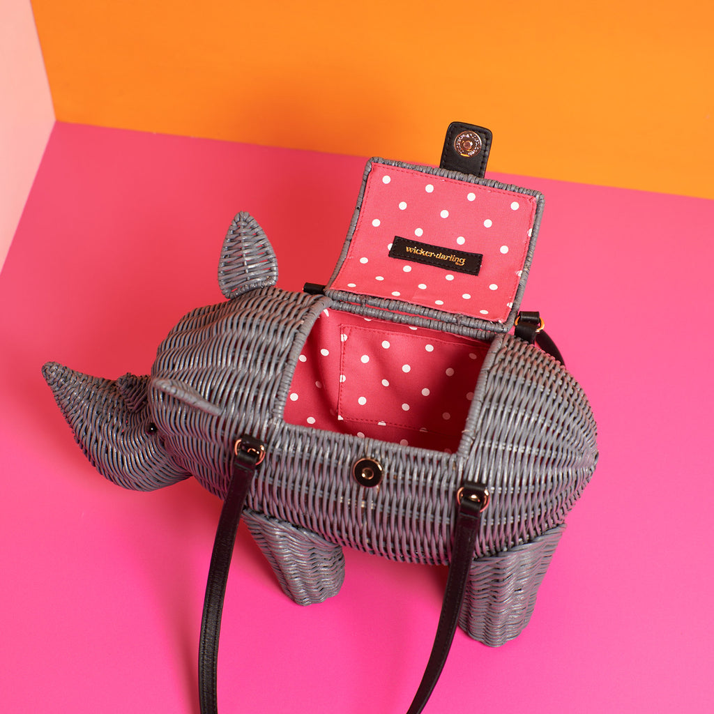 Wicker Darling Rhino purse rhino shaped bag sitting in a brightly coloured room