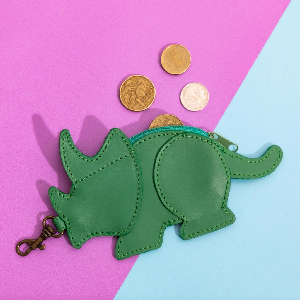 Wicker Darling benedict dinosaur coin purse dinosaur purse charm sits on a purple and blue background