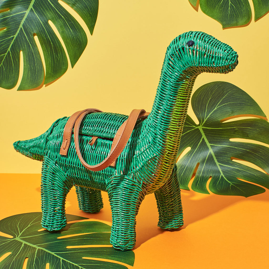 Wicker Darling charlotte brontesaurus dinosaur purse dinosaur handbag stands in a colourful background