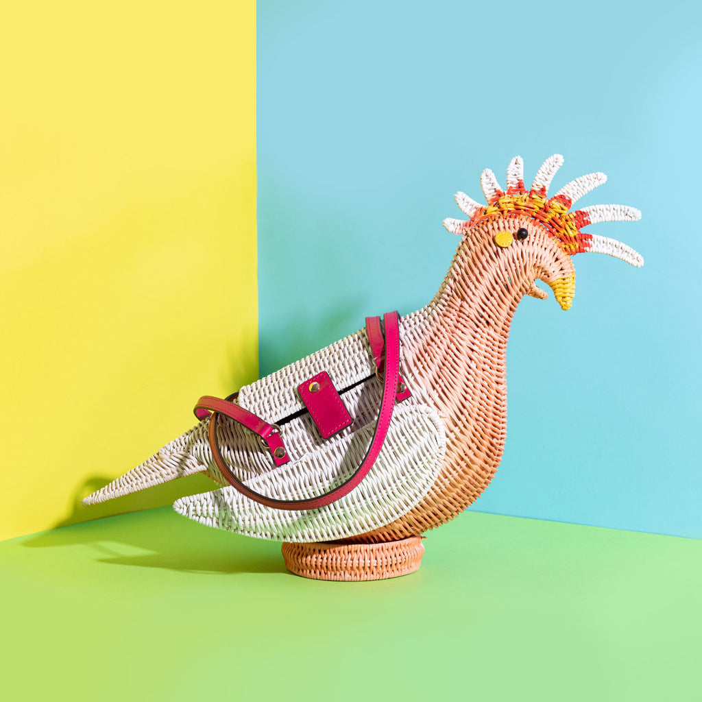 Wicker Darling gary major mitchell cockatoo purse sits in a colourful room