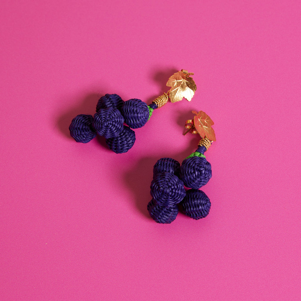 Wicker Darling Casa Bonita collab Woven Grape earrings sit on a colourful background