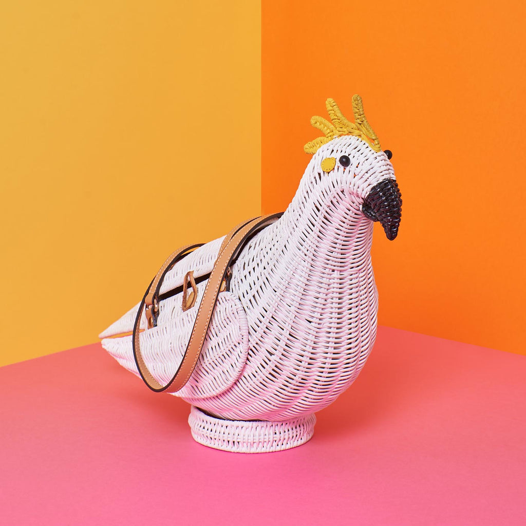 Wicker Darling iva cockatoo parrot purse australiana sits in a colourful background