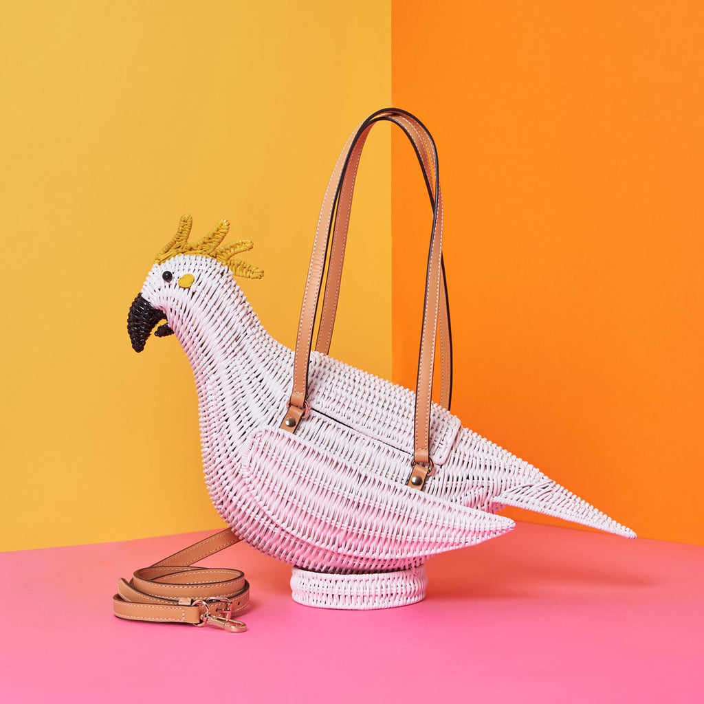 Wicker Darling iva cockatoo parrot purse australiana sits in a colourful background