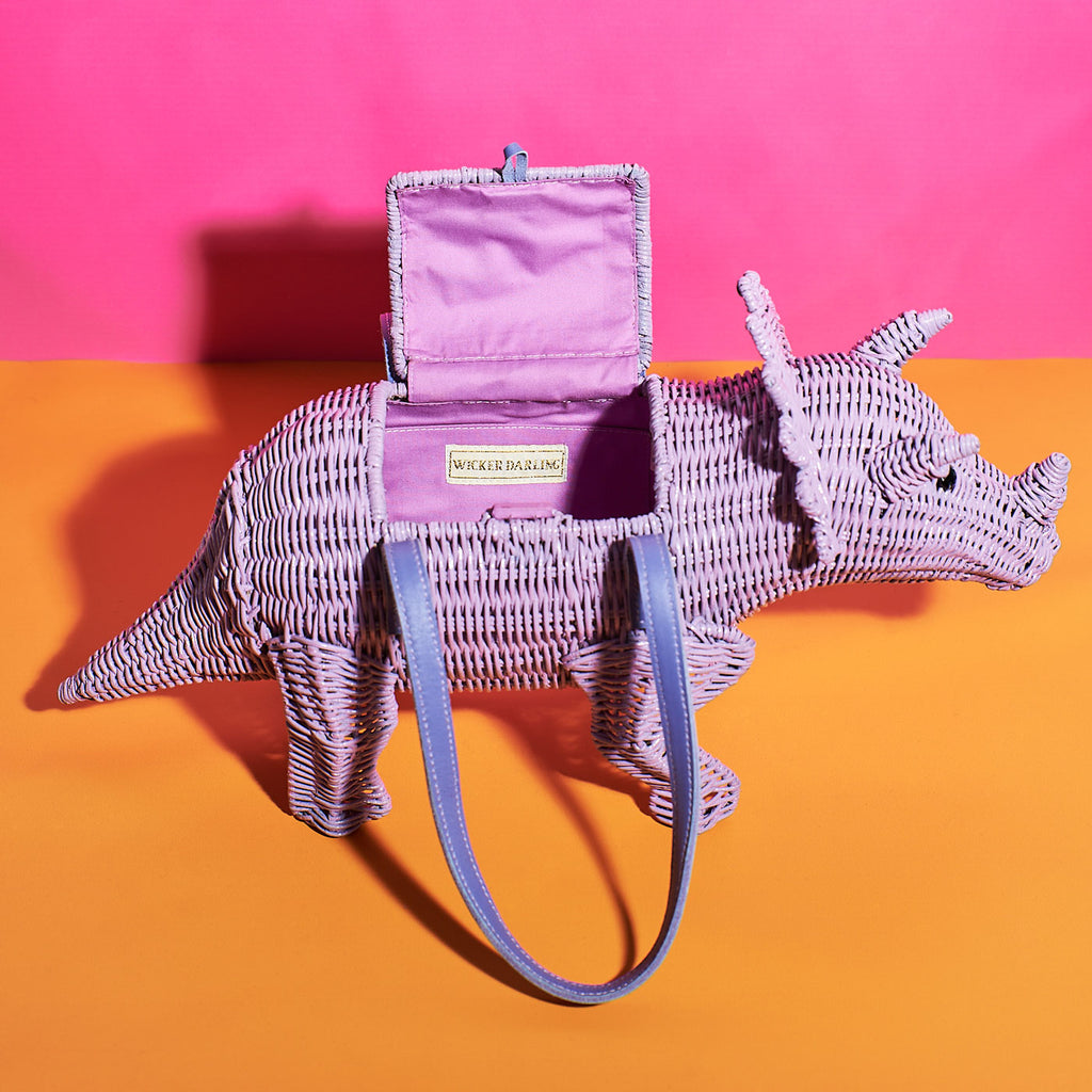 Wicker Darling patricia triceratops purple dinosaur wicker handbag dinosaur purse in a colourful background