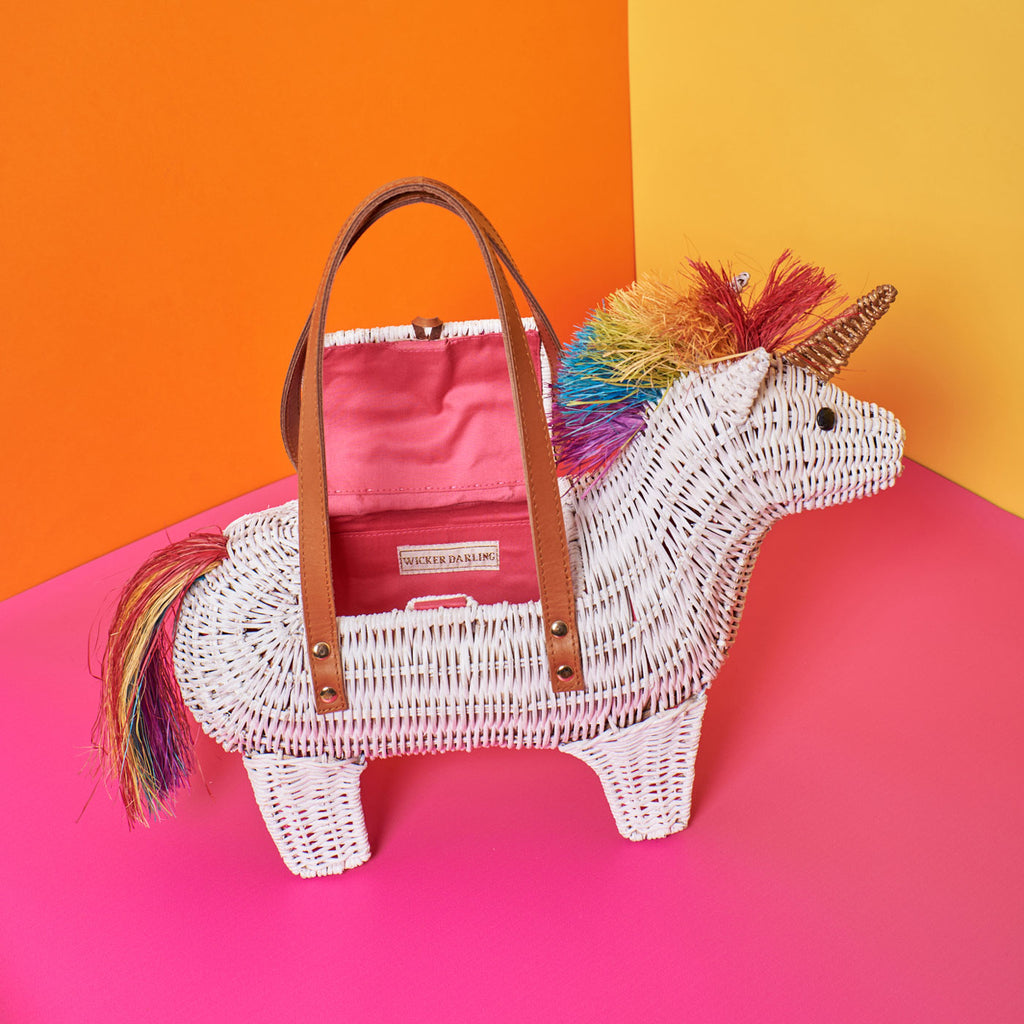 Wicker Darling victor rainbow unicorn bag unicorn purse sits in a colourful room