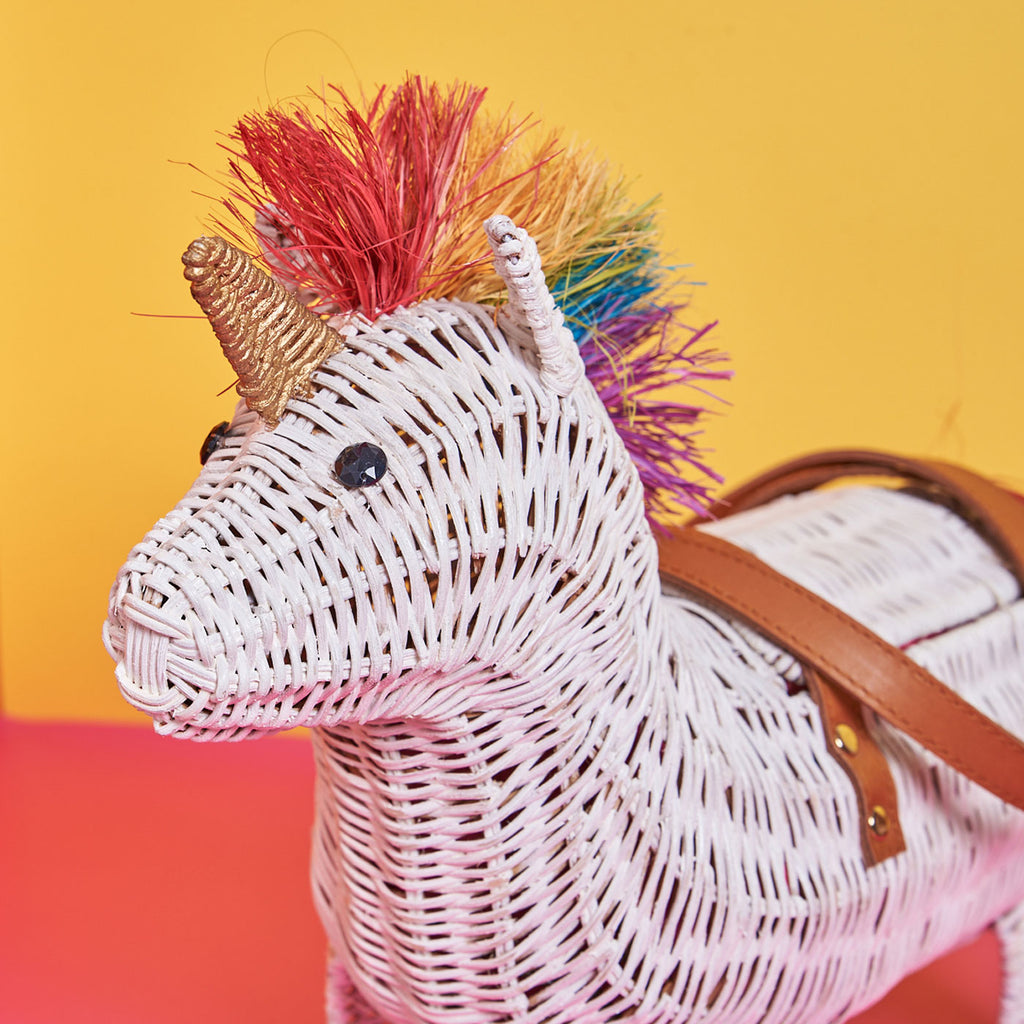 Wicker Darling victor rainbow unicorn bag unicorn purse sits in a colourful room