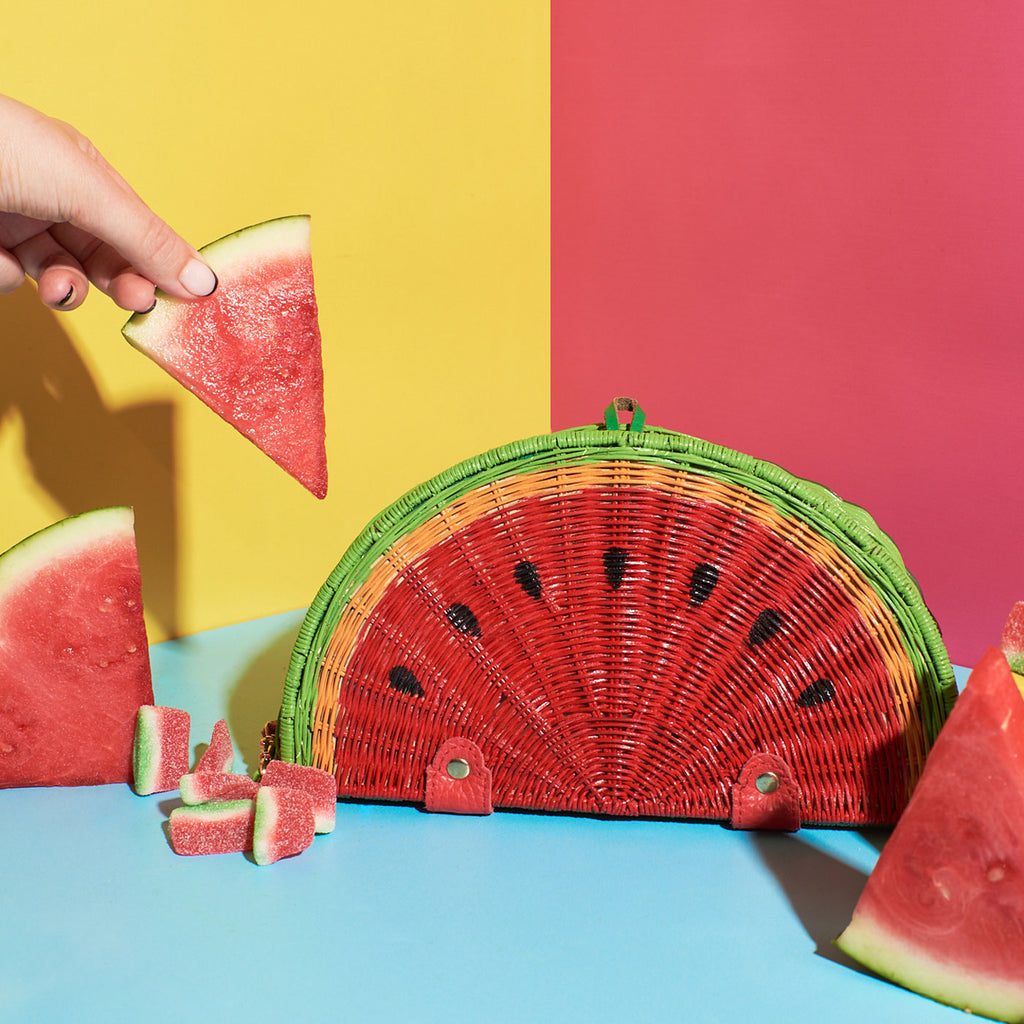 Wicker Darling mini watermelon shaped purse watermelon bag sitting in a colourful backkground